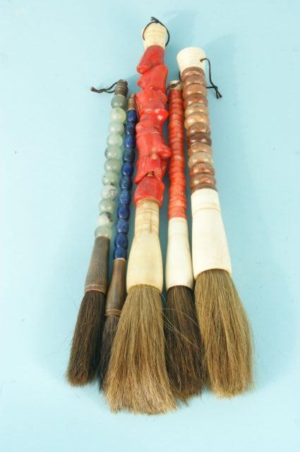 FIVE SEMI-PRECIOUS STONE BRUSHES: FIVE SEMI-PRECIOUS STONE BRUSHES. ORANGE SEA GRASS, RED SEA GRASS, BLUE STONE, JADE BALLS, BROWN STONE DISKS. Height: 12 in. by Width: 1 in. by Depth: 1 in.