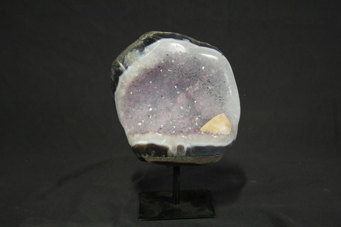 AGATE AND AMETHYST GEODE ON STAND: AGATE AND AMETHYST GEODE ON STAND WITH CALCITE INCLUSION - (AG98) 6.8 LBS. Height: 9.5 in. by Width: 6.5 in. by Depth: 4 in.