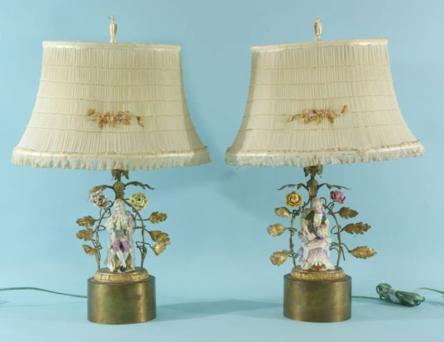 PAIR OF PORCELAIN FIGURES CONVERTED TO LAMPS: PAIR OF PORCELAIN FIGURES CONVERTED TO LAMPS WITH GILD BRONZE DORE SURROUNDING FIGURES AND PLEATED AND FRILLED SHADES. Height: 22 and 10 in. by Width: 15 in. by Depth: 11 in.