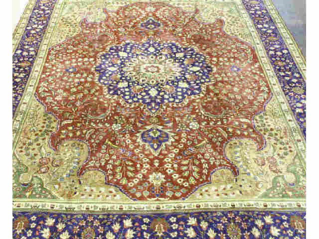 SEMI-ANTIQUE FLORAL TABRIZ RUG FROM IRAN: SEMI-ANTIQUE FLORAL TABRIZ RUG. IN OLIVE, RUSTS AND PLUM. ORIGIN: PERSIA/IRAN Height: 9 ft. 7 in. by Width: 13 ft. 1 in.
