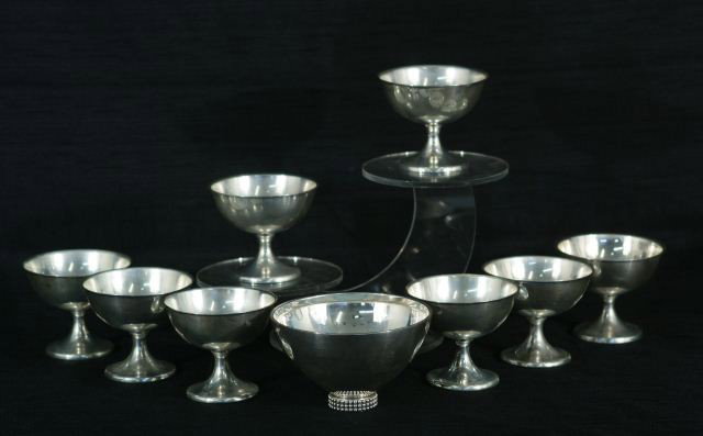 LOT OF NINE STERLING SILVER PIECES: LOT OF NINE STERLING SILVER PIECES. EIGHT CHAMPAGNE GLASSES BY WALLACE, ONE MADE IN GERMANY FOOTED BOWL. Weight is 40.40 ounces. Height: 3 and 3 in. by Width: 5 1/4 and 3 3/4 in. by Depth: 5 1/4 and 3