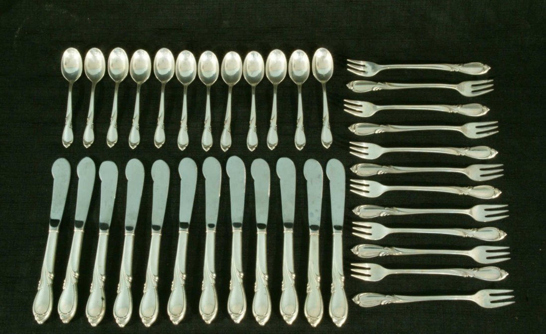 LOT OF THIRTY-SIX SILVERWARE PIECES BY RHAPSODY: LOT OF THIRTY-SIX SILVERWARE PIECES. STERLING SILVER BY RHAPSODY INTERNATIONAL STERLING. TWELVE SHRIMP FORKS, TWELVE TEASPOONS, TWELVE BUTTER KNIVES.