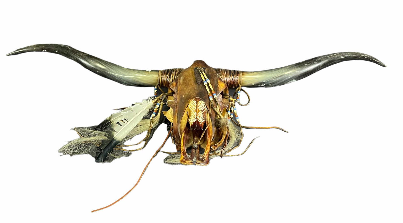 CARVED AND PAINTED LONGHORN SKULL MOUNT: CARVED AND PAINTED LONGHORN SKULL MOUNT. Height: 16 in. by Width: 52 in. by Depth: 5 in.