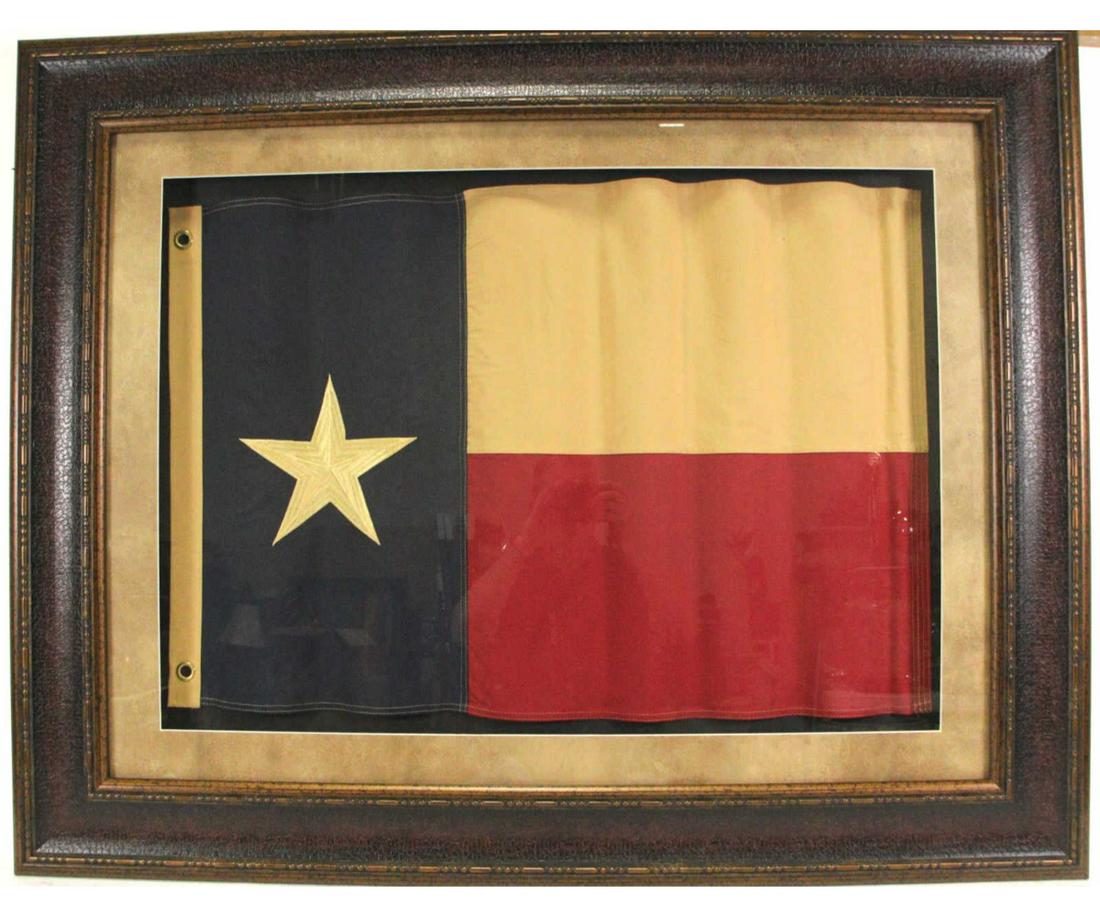 FRAMED WAVY HAND STITCHED TEXAS FLAG: FRAMED WAVY HAND STITCHED TEXAS FLAG. Height: 39 in. by Width: 49 in.