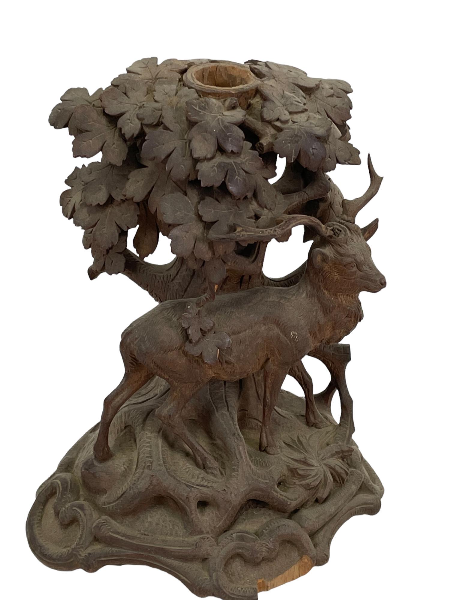 ANTIQUE BLACK FOREST WOOD CARVED CANDLESTICK: ANTIQUE BLACK FOREST WOOD CARVED CANDLESTICK. Height: 9 in. by Width: 8 in. by Depth: 6 in.