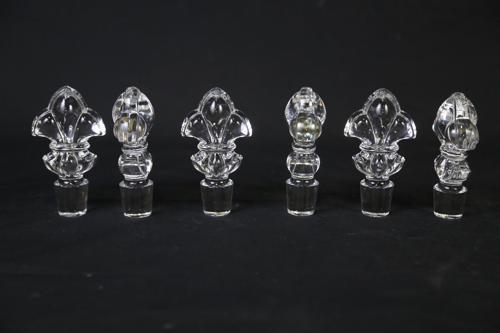 SET OF SIX FLEUR DE LIS BACCARAT BOTTLE STOPPERS: SET OF SIX FLEUR DE LIS BACCARAT CRYSTAL BOTTLE STOPPERS Height: 4 in. by Width: 3 in. by Depth: 1 IN.