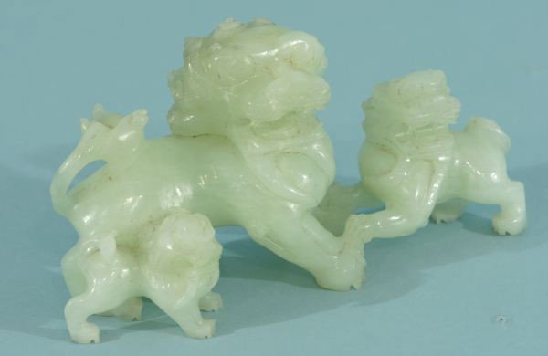 CARVED JADE FOO DOG SCULPTURE: CARVED JADE FOO DOG SCULPTURE. Height: 11 in. by Width: 22 in. by Depth: 8 in.