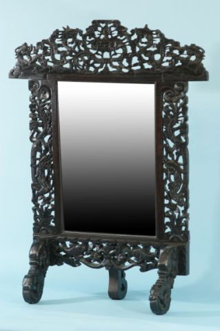 AN IMAGINATIVE CELESTIAL DRAGON MIRROR: AN IMAGINATIVE CELESTIAL DRAGON MIRROR. CARVED WOOD WITH NINE DRAGONS ON A TRIPOD STAND. Height: 32 1/2 in. by Width: 24 1/2 in. by Depth: 10 1/2 in.