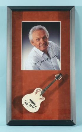 PHOTO AND MINI GUITAR SIGNED BY MEL TILLIS: PHOTO AND MINI GUITAR SIGNED BY MEL TILLIS.