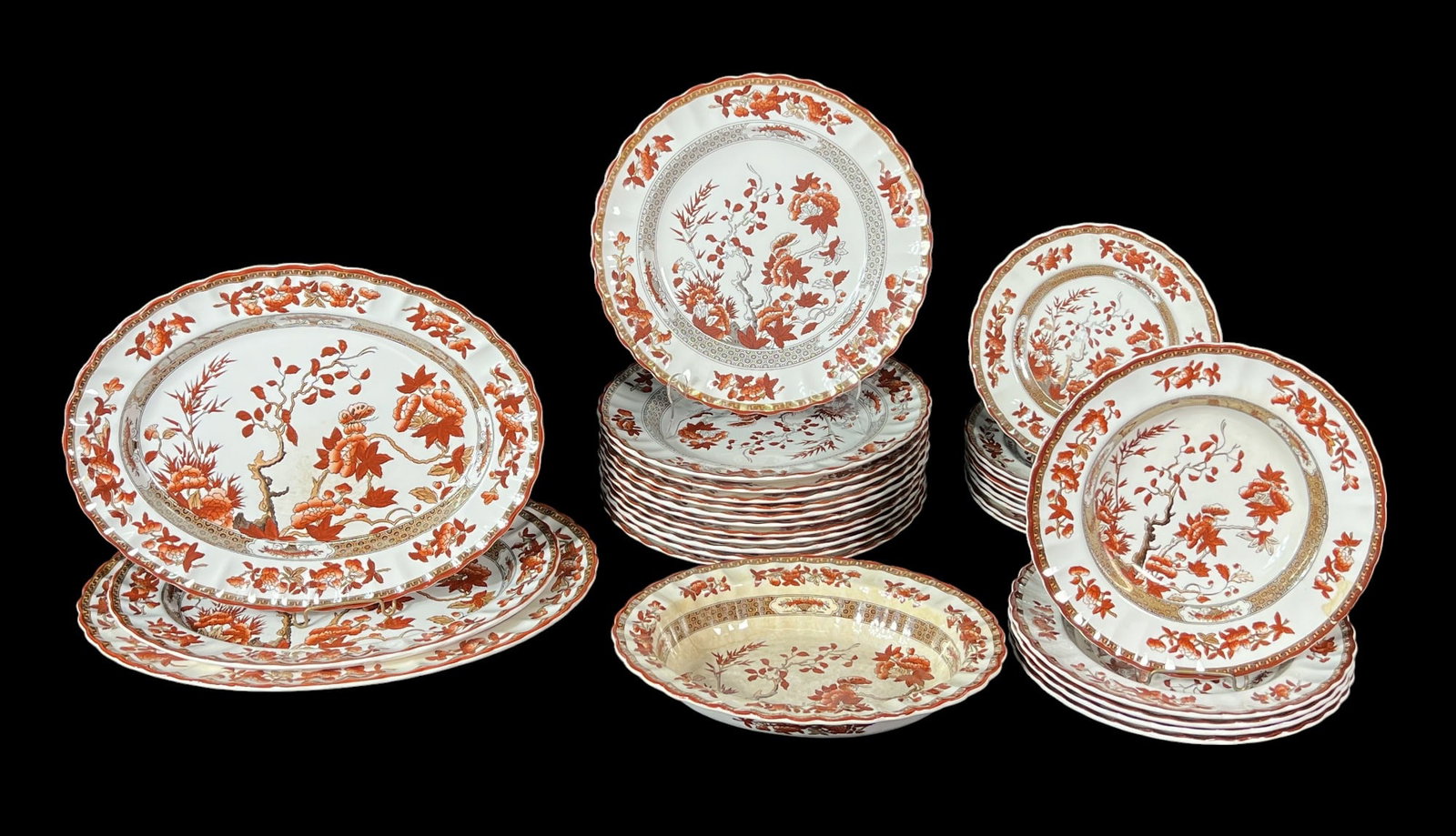 30-PC. SPODE INDIA TREE ORANGE RUST DINNERWARE: 30-PIECE ASSEMBLED SET OF SPODE INDIA TREE ORANGE RUST DINNERWARE. 3 PLATTERS, 1 SERVING PLATTER WITH REPAIR, 9 SALAD PLATES, 5 SOUP BOWLS, 12 DINNER PLATES.