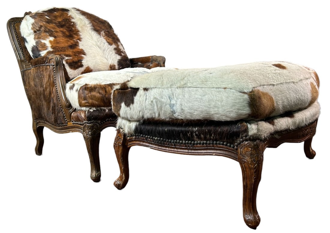 19th CENTURY FRENCH ARMCHAIR AND OTTOMAN: 19th CENTURY FRENCH ARMCHAIR AND OTTOMAN UPHOLSTERED IN COWHIDE. Height: 37 in. by Width: 32 in. by Depth: 28 in.