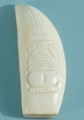 TUSK WITH SCRIMSHAW OF TAHITIAN FIGURE: TUSK WITH SCRIMSHAW OF TAHITIAN FIGURE CAPPED WITH MOTHER-OF-PEARL. Height: 4 in. by Width: 1 1/2 in. by Depth: 1 in.