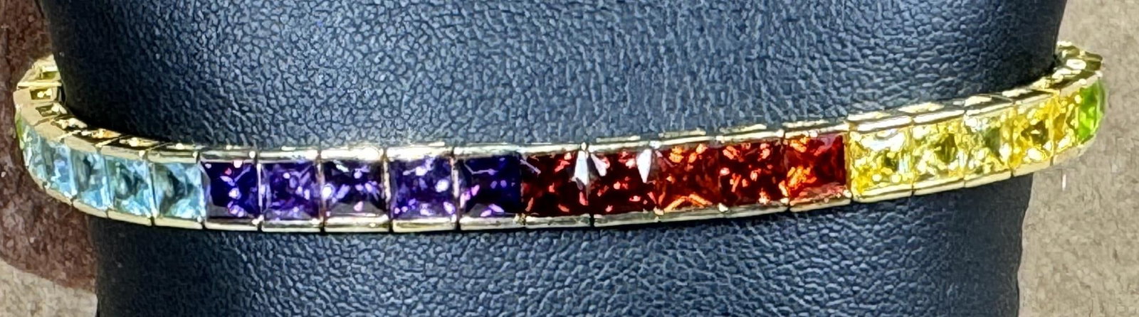 BLUE TOPAZ, GARNET, PERIDOT, AMETHYST BRACELET: BLUE TOPAZ, GARNET, PERIDOT, AMETHYST GOLD WASH OVER STERLING SILVER BRACELET.