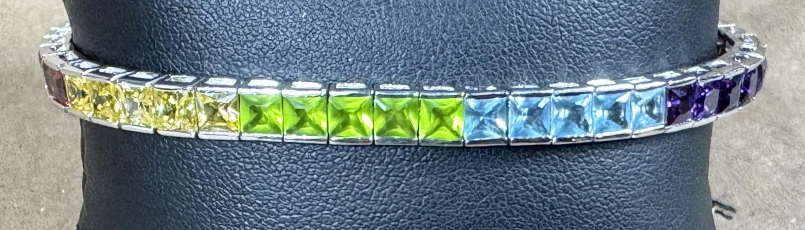 BLUE TOPAZ, GARNET, PERIDOT, AMETHYST BRACELET: BLUE TOPAZ, GARNET, PERIDOT, AMETHYST GOLD WASH OVER STERLING SILVER BRACELET.