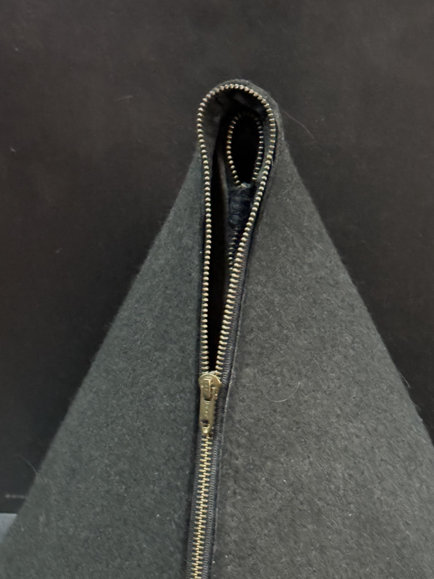 JESSE AMADO "ZIPPER" ON A SHELF: JESSE AMADO "ZIPPER" ON A METAL SHELF Height: 16 in. by Width: 16 in. by Depth: 16