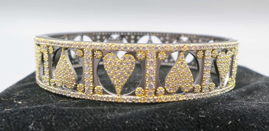 GILT BRASS PAVE TRIM & HEARTS BANGLE BRACELET: GILT BRASS PAVE TRIM & HEARTS BANGLE BRACELET. Height: 2 1/4 in. by Width: 2 in. by Depth: 9 16 in.