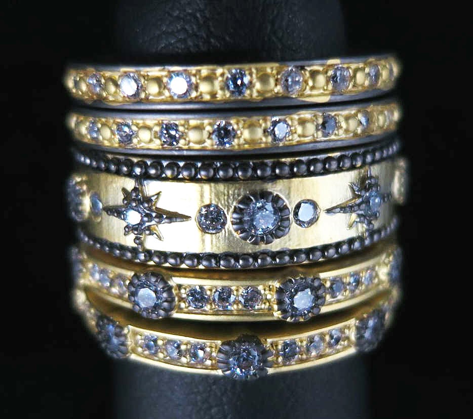 5-STACK BLACK & GILT CZ STARBURST RING SET: 5-STACK BLACK & GILT CZ STARBURST RING SET. SIZE 7 .
