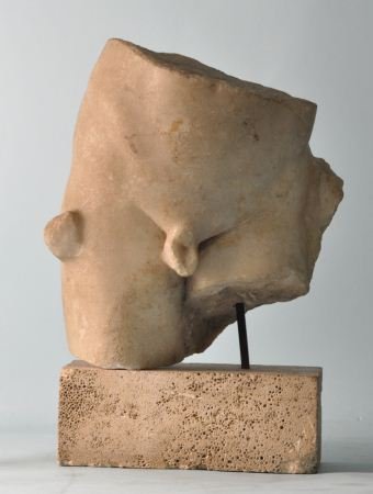 ROMAN MARBLE MALE TORSO, C. 1st-2nd C. A.D.: ROMAN CARVED MARBLE MALE TORSO ON LATER LIMESTONE BASE. CIRCA 1st to 2nd CENTURY A. D. PROVENANCE: FOSTER-GWIN ART & ANTIQUES, SAN FRANCISCO, CA. Height: 16 in. by Width: 12 in. by Depth: 6 in.