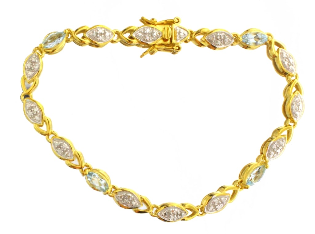 Natural Blue Topaz & Diamond Accented Bracelet: Natural Blue Topaz & Diamond Accented Bracelet Sterling Silver w/14kt Gold Overlay Gram Weight: 8.90 Gemstones: Natural Blue Topaz & Diamond 145
