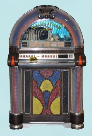 VINTAGE WURLITZER JUKEBOX: VINTAGE WURLITZER JUKEBOX PLAYS 45 RPMS. Height: 58 in. by Width: 36 in. by Depth: 27 1/2 in.