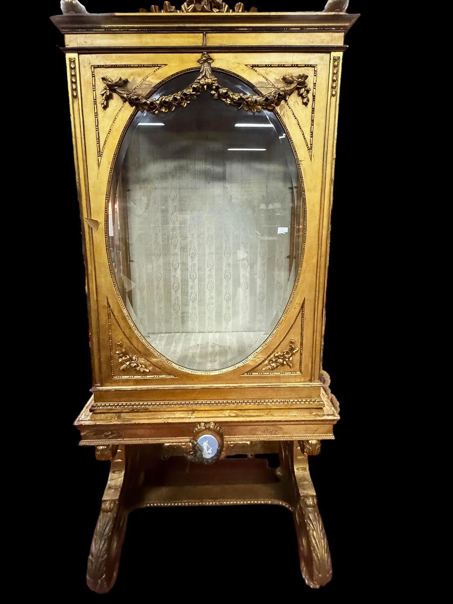 ANTIQUE FRENCH GILDED VITRINE: ANTIQUE FRENCH GILDED VITRINE WITH PORCELAIN PLAQUE, BEVELED GLASS, CARVED SWAG RAISED ON LOUIS XIV LEGS. NO SHELVES. Height: 88 in. by Width: 36 in. by Depth: 23 in.