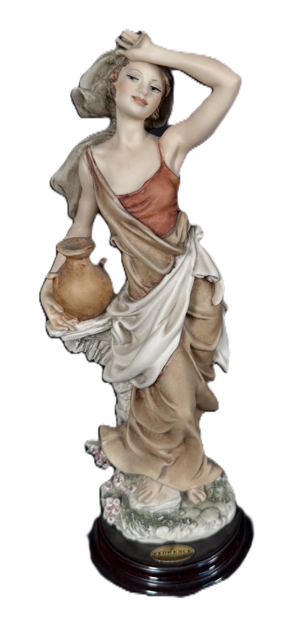 GUISEPPE ARMANI "CLEAR WATER" FIGURINE: GUISEPPE ARMANI "CLEAR WATER" FIGURINE. Height: 12 in. by Width: 4 1/4 in. by Depth: 4 in.