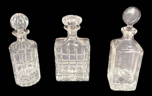 THREE CRYSTAL CUT GLASS DECANTERS: THREE CRYSTAL CUT GLASS DECANTERS.