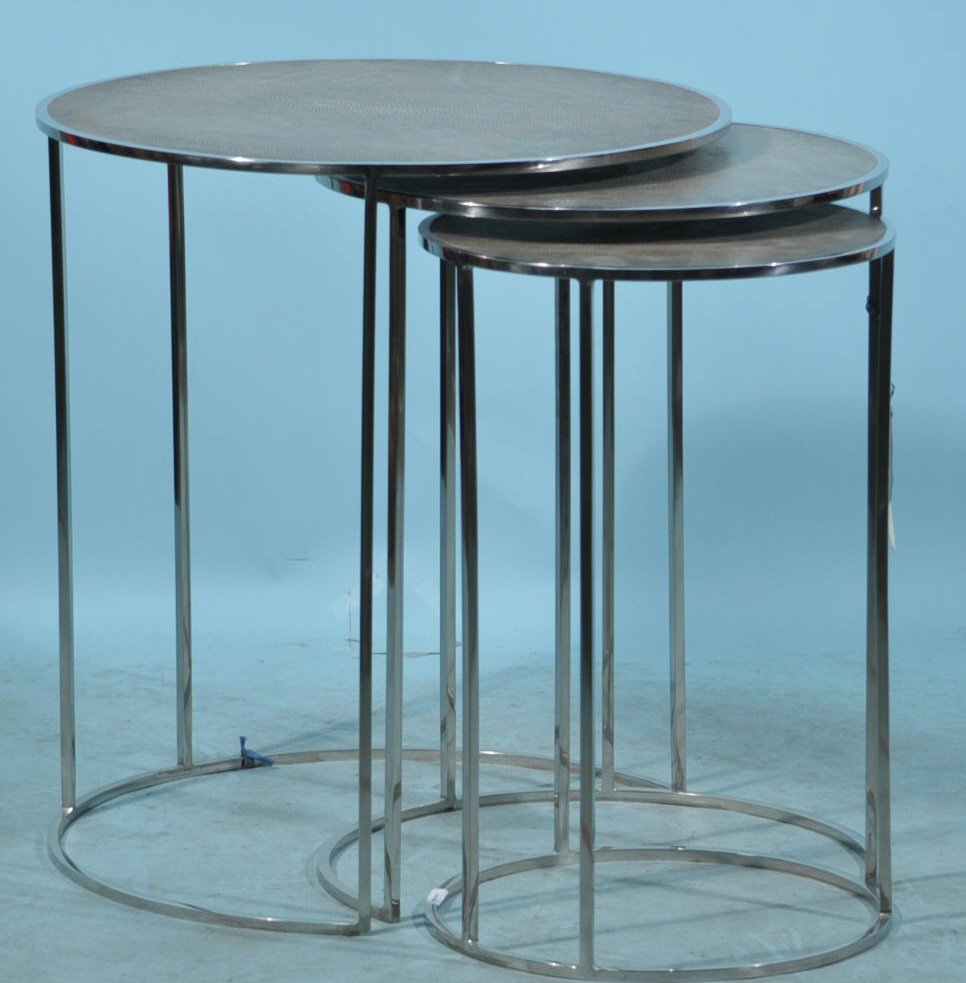 NEST OF THREE STAINLESS STEEL TABLES: NEST OF THREE STAINLESS STEEL TABLES WITH EMBOSSED SHARGREEN LEATHER TOPS INSPIRED BY ART DECO ORIGINALS. Height: 24 in. by Depth: 22 in.
