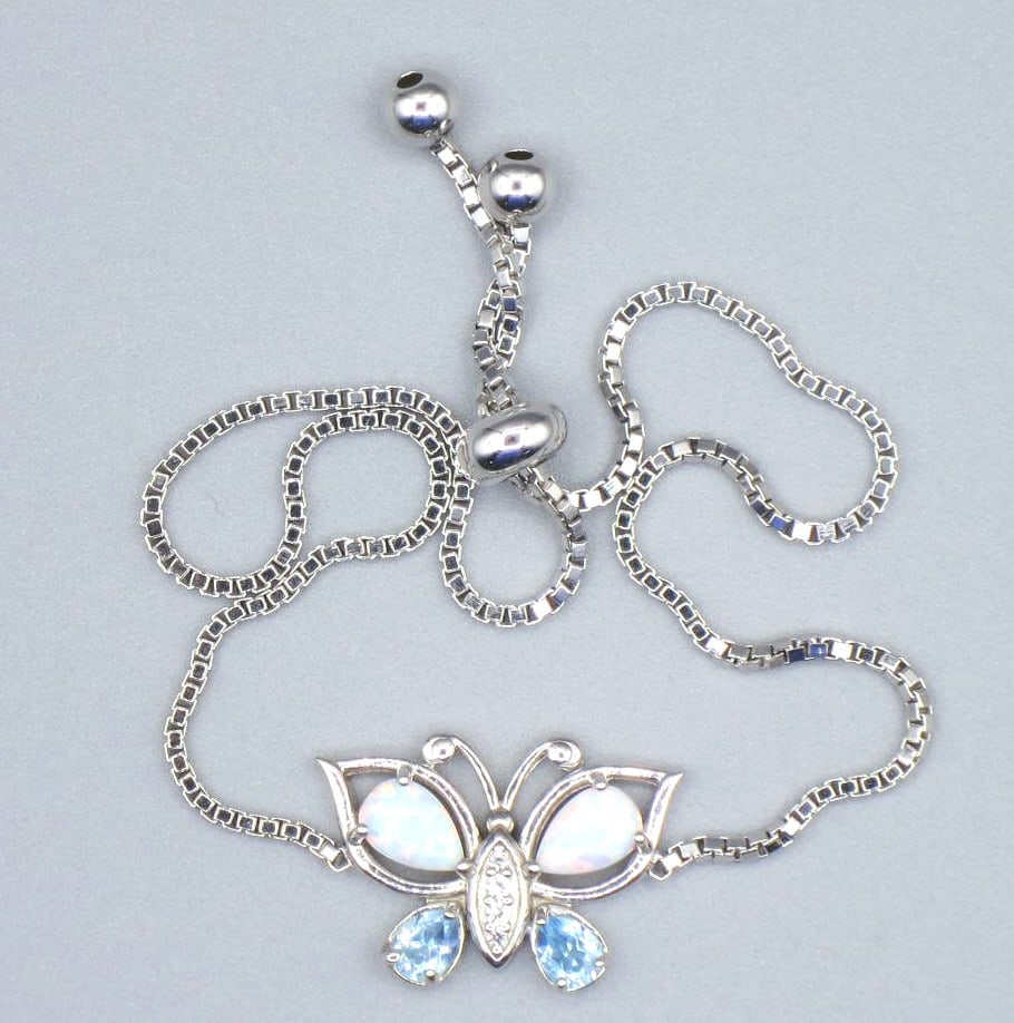 AQUAMARINE, OPAL BUTTERFLY BRACELET: AQUAMARINE, OPAL STERLING SILVER BUTTERFLY BRACELET. 8" ADJUSTABLE. Height: .5 in. by Width: 3/4 in. by Depth: 1/8 in.