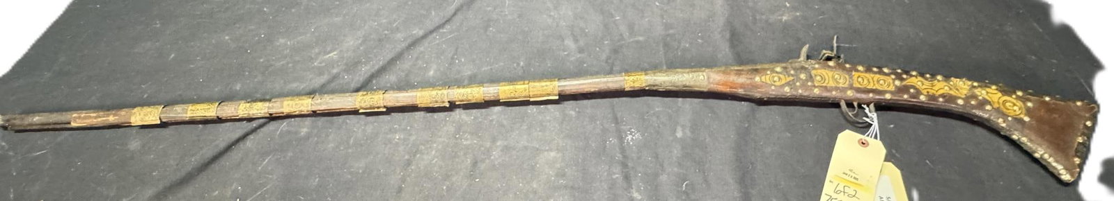 NORTH AFRICAN MOUKAHLA INERT DISPLAY RIFLES: NORTH AFRICAN MOUKAHLA INERT DISPLAY RIFLES Non functioning North African style Moukahala display rifle Wood and metal construction. 48.50 inch barrels, 63.50 inch overall lengths. Antique No FFL.