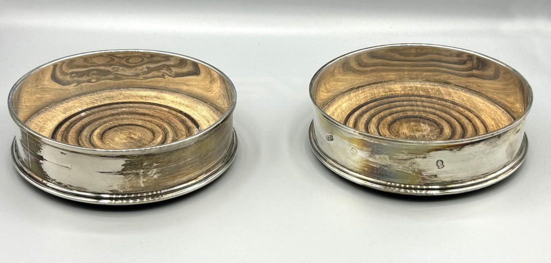 PAIR OF STERLING SILVER COASTERS WITH WOODEN LINER: PAIR OF STERLING SILVER COASTERS WITH WOODEN INNER LINERS. Height: 1.5 in. by Width: 5 in.