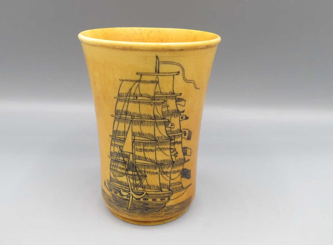 SCRIMSHAW "THE DAKOTA" SHOT GLASS: SCRIMSHAW "THE DAKOTA" SHOT GLASS. Height: 2.5 in. by Width: 1 3/4 in.