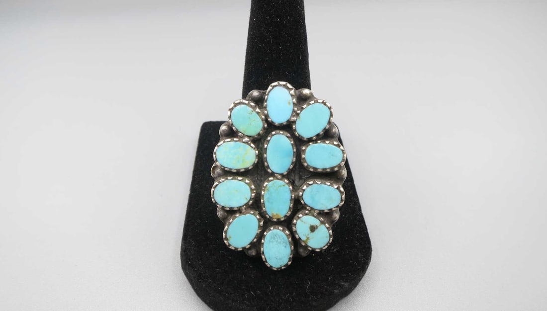 SILVER TURQUOISE FLOWER RING: SILVER TURQUOIOSE FLOWER RING. SIZE 7.