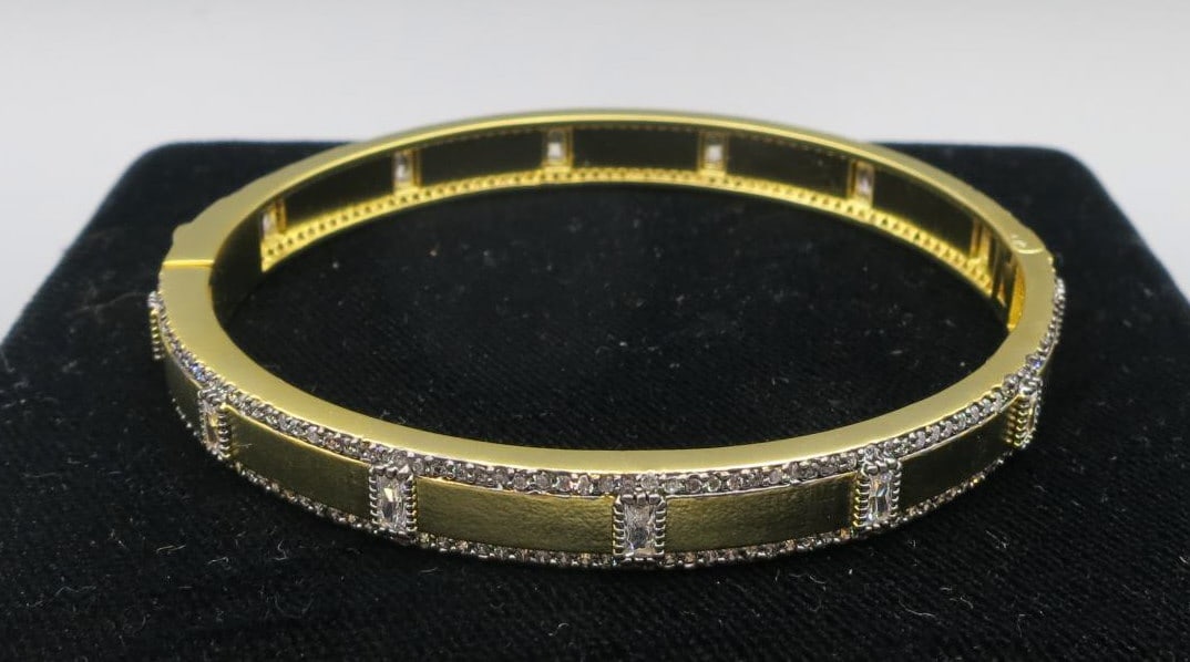 GILT BRASS CZ STONE PAVE TRIM SLIM BANGLE BRACELET: GILT BRASS CZ STONE PAVE TRIM SLIM BANGLE BRACELET. Height: 2 1/4 in. by Width: 2 5/8 in. by Depth: 1/4 in.