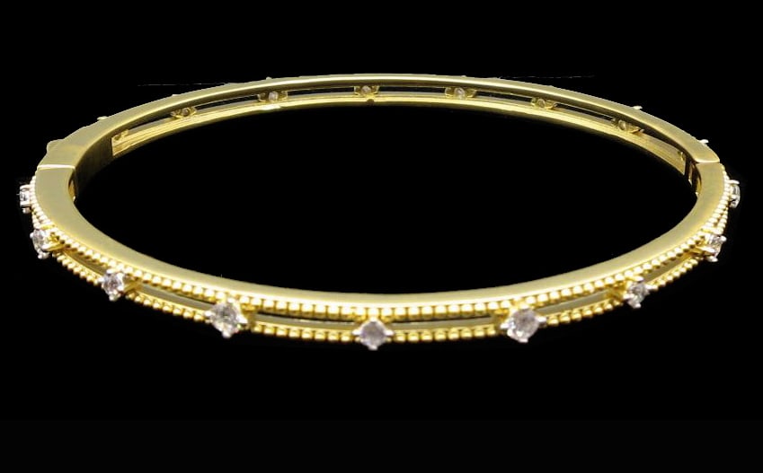 SLIM GILT BRASS PAVE CZ BANGLE BRACELET: SLIM GILT BRASS PAVE CZ BANGLE BRACELET. Height: 2 1/4 in. by Width: 2 1/8 in. by Depth: 3/16 in.