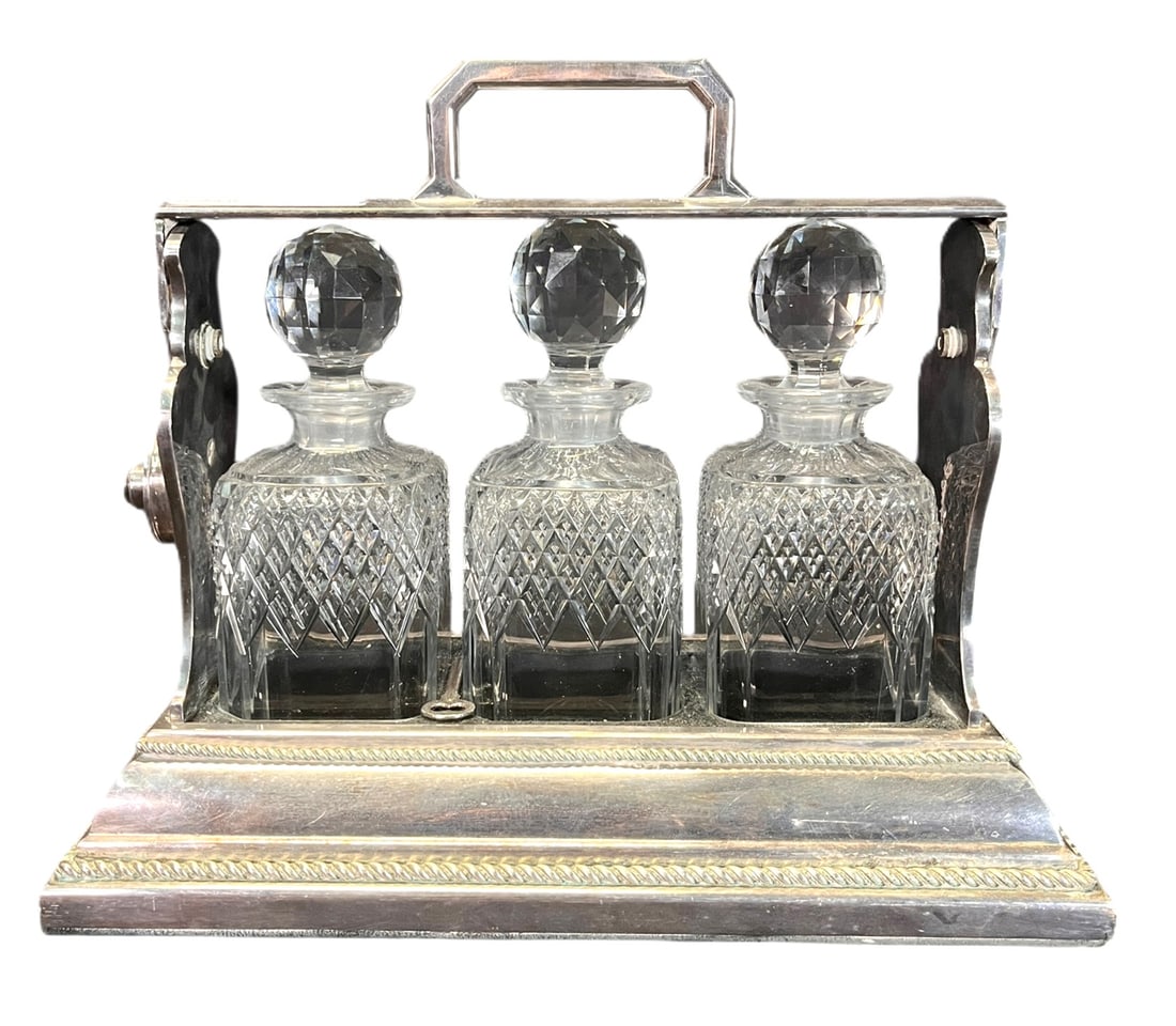 ANTIQUE SILVER PLATE TANTALUS: ANTIQUE SILVER PLATE TANTALUS WITH CUT CRYSTAL DECANTERS Height: 12 in. by Width: 13.8 in. by Depth: 6.8 in.