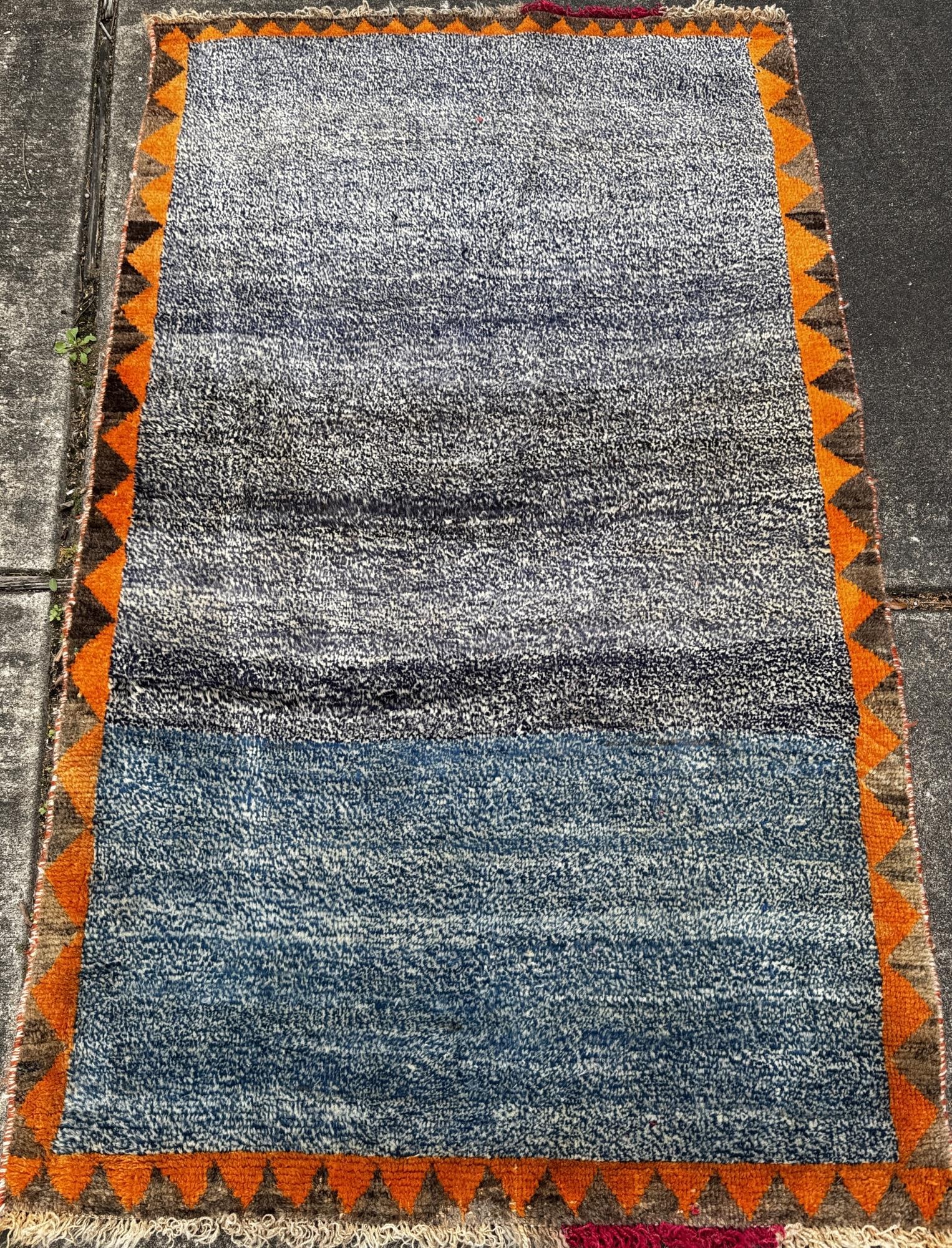 HAND KNOTTED TIBETAN CARPET: HAND KNOTTED TIBETAN CARPET WITH ORANGE BORDER. Height: 67 in. by Width: 38 in.