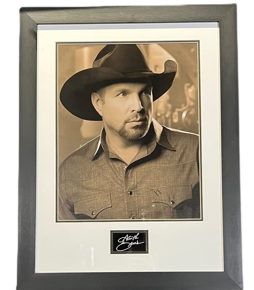 GARTH BROOKS PHOTOGRAPH AND SIGNATURE FRAMED: GEORGE STRAIGHT PHOTOGRAPH AND SIGNATURE FRAMED Height: 30.5 in. by Width: 23.5 in.
