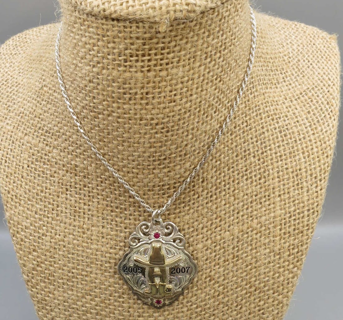 STERLING LIVESTOCK SHOW & RODEO MEDALLION/CHAIN: STERLING LIVESTOCK SHOW & RODEO MEDALLION ON 24" CHAIN. Height: 1.5 in. by Width: 1.25 in. by Depth: .25 in.