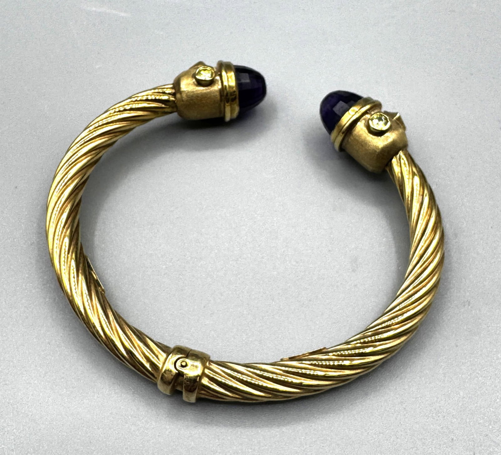 14KT GOLD ITALIAN CITRINE & AMETHYST GOLD CUFF: 14KT GOLD ITALIAN CITRINE & AMETHYST GOLD HINGED CUFF BRACELET. 18 GRAMS T. W. INSIDE DIAMETER 2 X 1.5 INCHES.