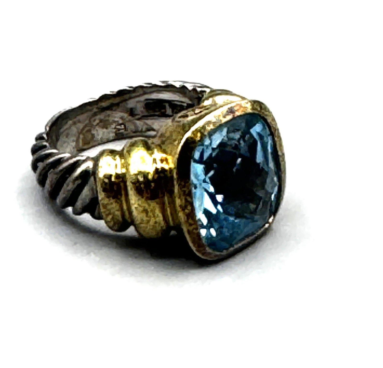 DAVID YURMAN NOBLESSE BLUE TOPAZ RING: DAVID YURMAN NOBLESSE RING CRAFTED WITH STERLING SILVER CABLE BAND AND A 14KT YELLOW GOLD BEZEL HOLDING FACETED BLUE TOPAZ STONE. SIZE 6. TOTAL WEIGHT: 14 GRAMS.