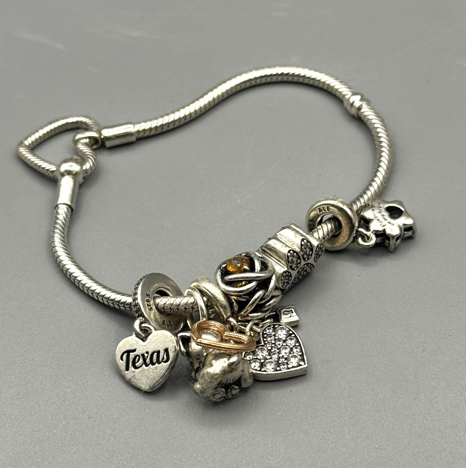 STERLING SILVER SNAKE CHAIN CHARM BRACELET: STERLING SILVER SNAKE CHAIN CHARM BRACELET. 2 INCH INSIDE DIAMETER. 33 GRAMS T. W.