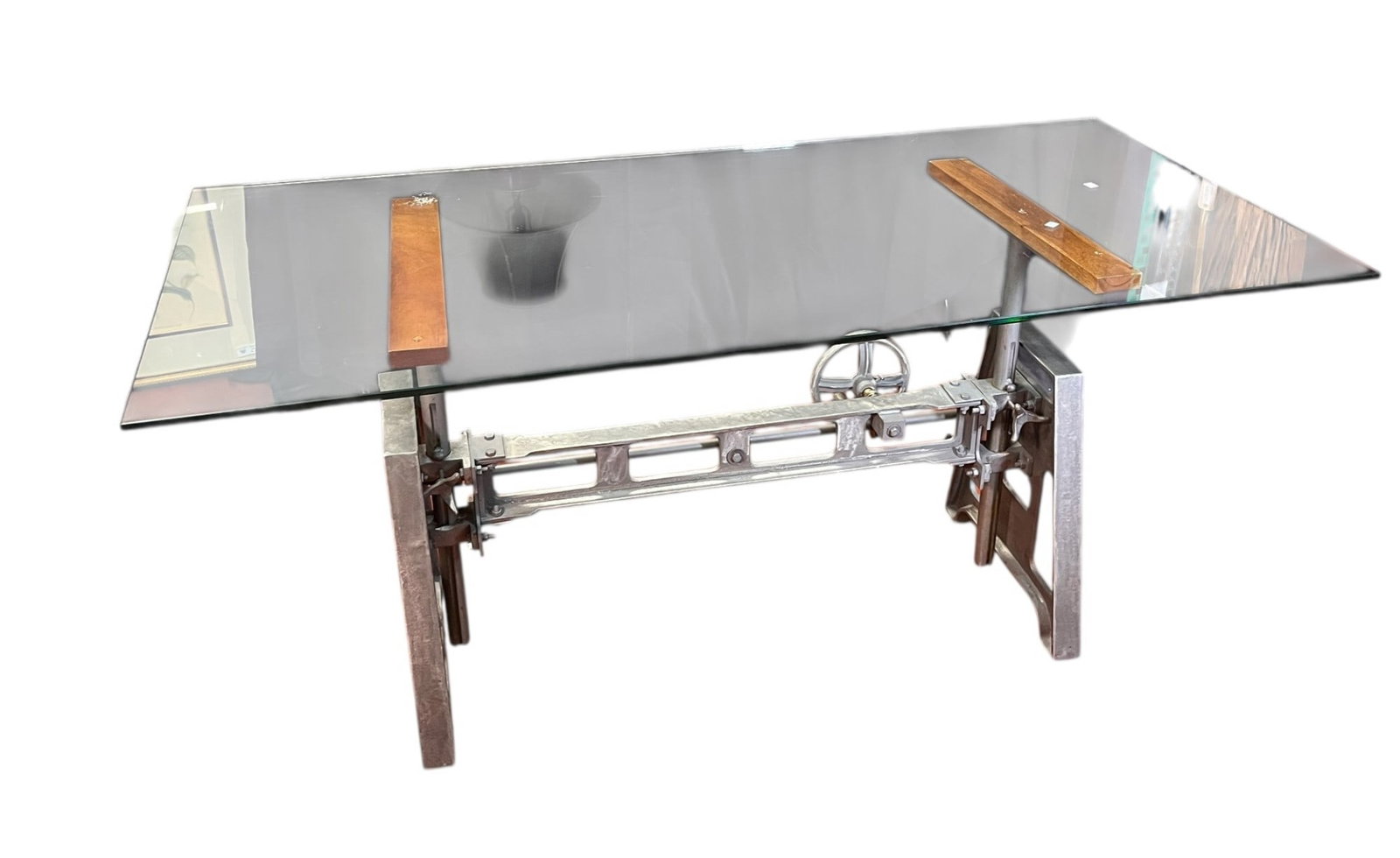 INDUSTRIAL CAST IRON/WOOD GLASS TOP DESK: INDUSTRIAL CAST IRON/WOOD GLASS TOP DESK. WILL CRANK DOWN TO A COFFEE TABLE. Height: 30.5 in. by Width: 68 in. by Depth: 32 in.