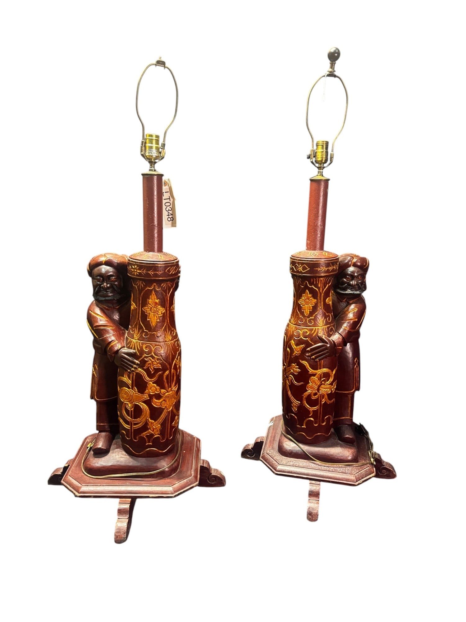 PR OF SOUTH ASIAN WOOD CARVED LAMPS WITH MALE FIG: PAIR OF SOUTH ASIAN WOOD CARVED LAMPS WITH MALE FIGURES CLUTCHING VASES. Height: 45 in. by Width: 20