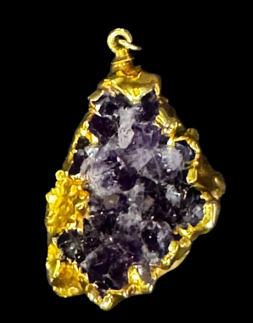 AMETHYST WRAPPED IN GOLD METAL PENDANT: AMETHYST WRAPPED IN GOLD METAL PENDANT. Height: 2 in. by Width: 1.25 in. by Depth: 5/8 in.