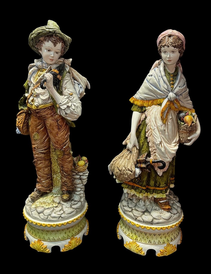 PAIR OF SIGNED MAJOLICA FIGURES: PAIR OF SIGNED MAJOLICA FIGURES, DEPICTING BOY AND GIRL SIGNED D. POLOUIATE. Height: 31.5 in. by Width: 11 in. by Depth: 11 in.