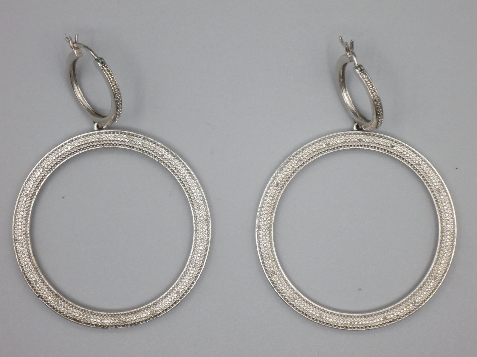 PAIR OF STERLING SILVER MICRO CZ PAVE HOOP EARRING: PAIR OF STERLING SILVER MICRO CZ PAVE HOOP EARRINGS. Height: 3 in. by Width: 2 in. by Depth: 1/8 in.