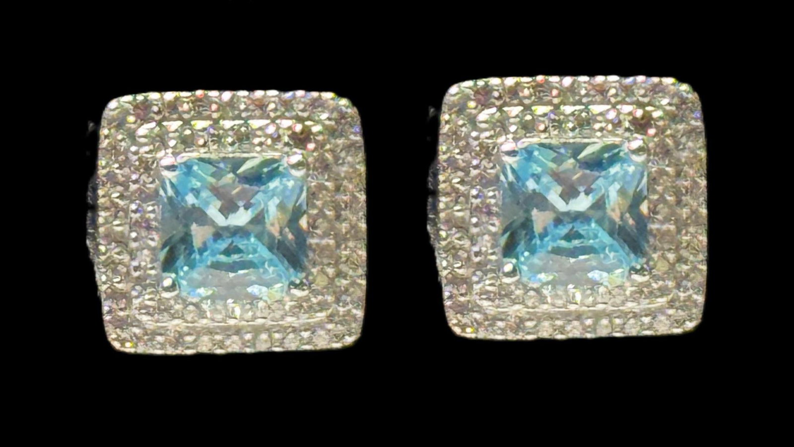 PAIR OF BLUE & WHITE TOPAZ EARRINGS: PAIR OF BLUE & WHITE TOPAZ EARRINGS. PIERECED EARS. Height: .5 in. by Width: .5 in. by Depth: 1/8 in.