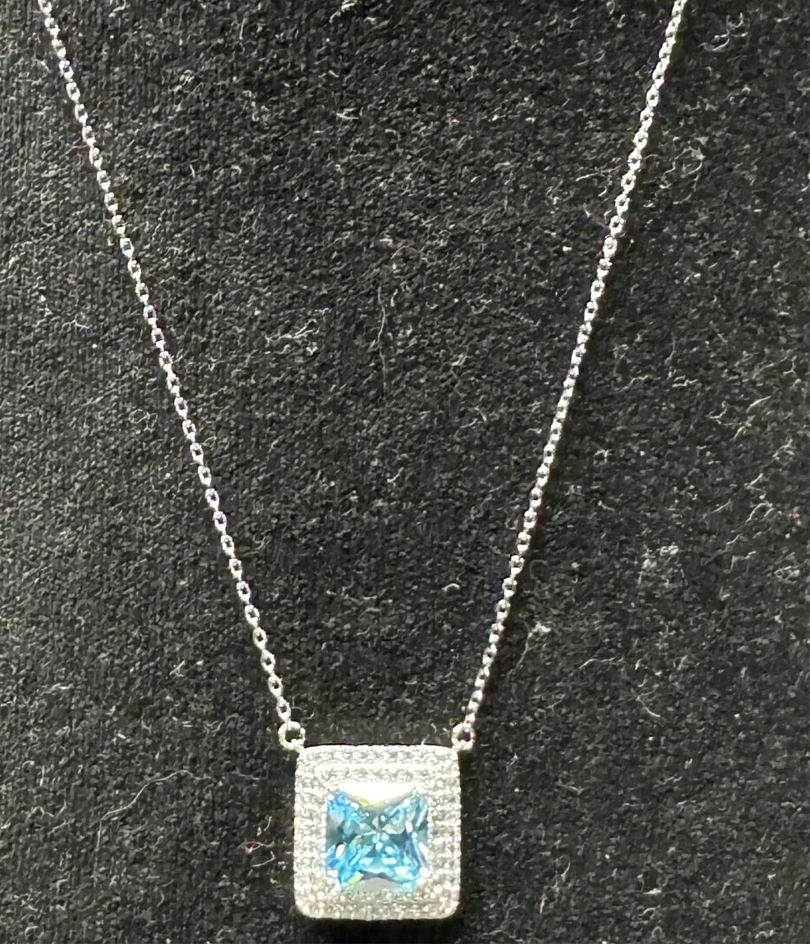 BLUE & WHITE TOPAZ NECKLACE: BLUE & WHITE TOPAZ NECKLACE- SQUARE CUT. ADJUSTABLE LENGTH. 8 TO 8.5" LONG. Height: 5/8 in. by Width: 5/8 in. by Depth: 3/16 in.