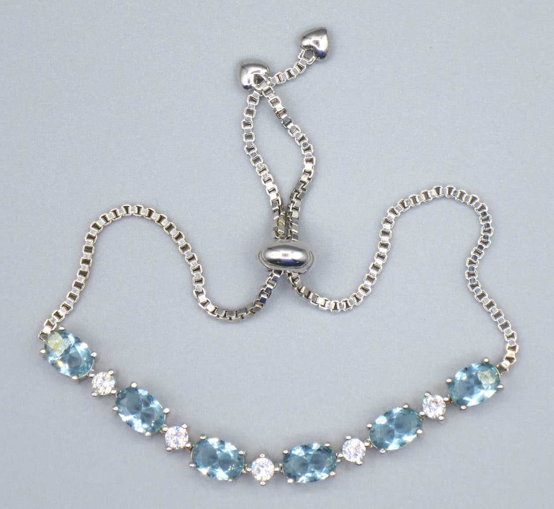 CZ DIAMOND & AQUAMARINE STERLING SILVER BRACELET: CZ DIAMOND & AQUAMARINE STERLING SILVER BRACELET. 8" ADJUSTABLE. Height: 1/4 in. by Width: 2 3/4 in. by Depth: 1/4 in.
